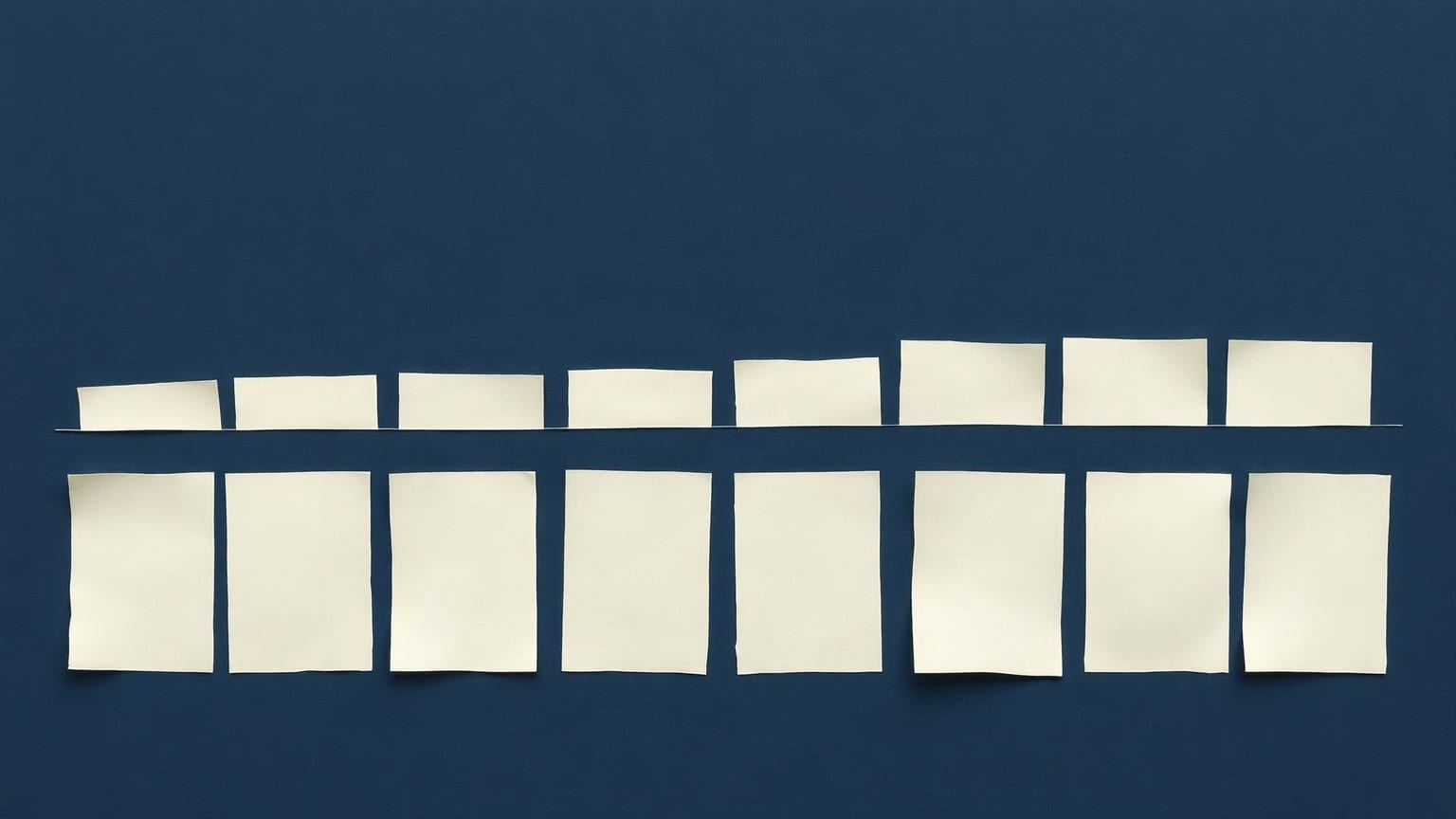 Twelve pale paper rectangles in a row on deep blue, the last three lifted onto a higher line