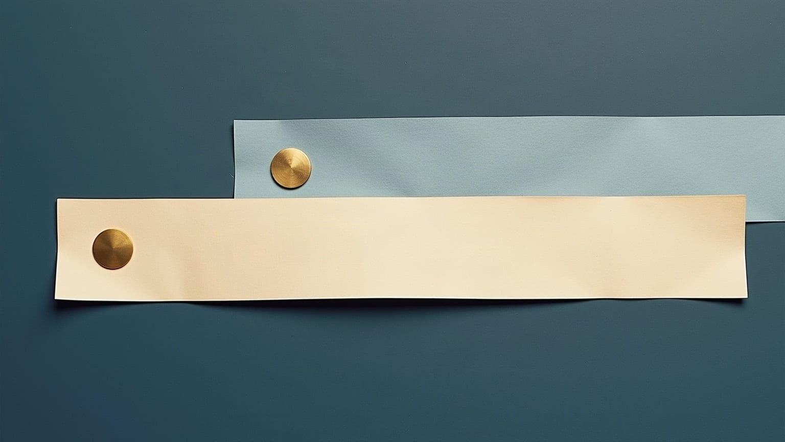 Cut-paper illustration: two pale paper bars of unequal length overlapping in a horizontal line, each fixed with a small brass disc.